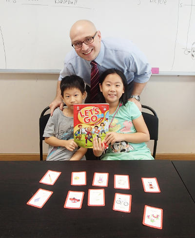 two kids learning English at Modulo with their teacher